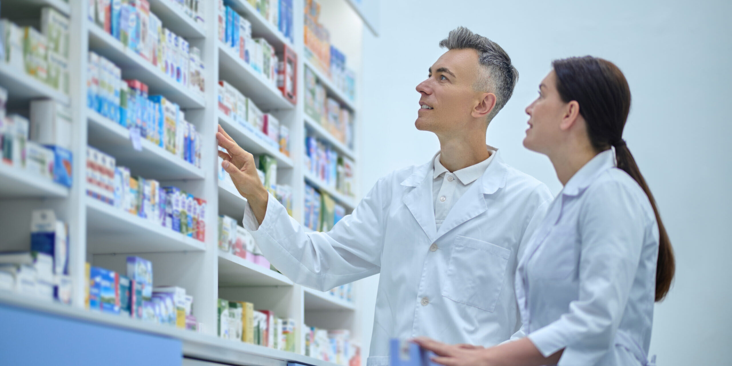 Two druggists in lab coats in the process of inventory in a drugstore Improving Employee Engagement in the Health & Community Sector