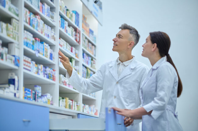Two druggists in lab coats in the process of inventory in a drugstore Improving Employee Engagement in the Health & Community Sector